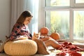 Woman with cute cat resting at home on autumn day Royalty Free Stock Photo