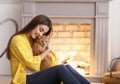 Woman with cute cat resting near fireplace Royalty Free Stock Photo