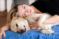 Woman with cute dogs at home. Handsome girl resting and sleeping with her dog in bed in bedroom. Owner and dog sleeping in sofa. Royalty Free Stock Photo