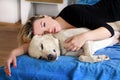 Woman with cute dogs at home. Handsome girl resting and sleeping with her dog in bed in bedroom. Owner and dog sleeping in sofa. Royalty Free Stock Photo