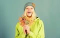 Woman cute face wear knitted hat hold fallen leaves. Autumn skincare tips. Skincare and beauty tips. How to update your