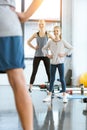 Woman and cute girl exercising with coach at fitness studio Royalty Free Stock Photo