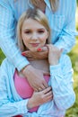 Woman cutely hold face of young girl. Blondie teenager with bright pink makeup gently touch hands of older one.