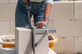 Woman cuts aerated concrete with a masonry saw Royalty Free Stock Photo