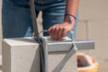 Woman cuts aerated concrete with a masonry saw. Gasbeton wall Royalty Free Stock Photo