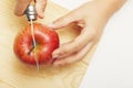 Woman cuts apple on cutting board. Organic agriculture concept. Copy space
