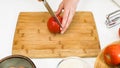 Woman cuts apples on a wooden cutting board. Royalty Free Stock Photo