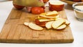 Woman cuts apples on a wooden cutting board. Royalty Free Stock Photo