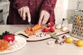 Woman cuts carrots with sharp knife on cutting board Royalty Free Stock Photo