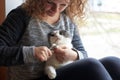 A woman cuts the claws of a cat with nail scissors, pet care Royalty Free Stock Photo