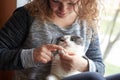 A woman cuts the claws of a cat with nail scissors, pet care Royalty Free Stock Photo