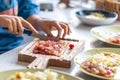 A woman cuts grapes on a cutting board. Royalty Free Stock Photo