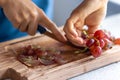 A woman cuts grapes on a cutting board. Royalty Free Stock Photo