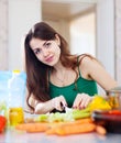 Woman cuts green celery at kitchen Royalty Free Stock Photo