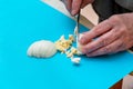 Woman cuts with a knife a white boiled egg Royalty Free Stock Photo