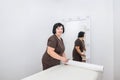 A woman cuts off a disposable sheet before a cosmetic or massage procedure