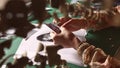 A woman cuts a photo with her hands to make a collage