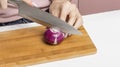 A woman cuts red onions on a salad cutting Board Royalty Free Stock Photo