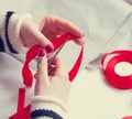 Woman cuts a red ribbon