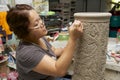 Woman cuts traditional tattoo motives decoration at kaolin, Kuching, Malaysia