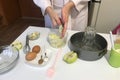 The woman is cutting apples. Cinnamon and baking powder in teaspoons. On the table are ingredients and tools for making charlotte