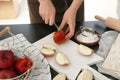 Woman cutting apples for pastry on wooden board Royalty Free Stock Photo