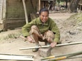 Woman cutting bamboo.