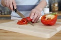 Woman cutting capsicum in the kitchen. Conceptual image Royalty Free Stock Photo