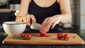 Woman cutting cherry tomatoes. Female hands preparing cherry tomatoes on wood board slow motion