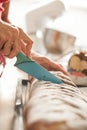 Woman cutting chocolate cake with sugar decoration with kitchen Royalty Free Stock Photo