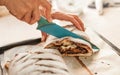 Woman cutting chocolate cake with sugar decoration with kitchen Royalty Free Stock Photo