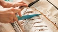 Woman cutting chocolate cake with sugar decoration with kitchen Royalty Free Stock Photo