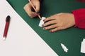 Woman cutting Christmas tree for Noel decoration. Flatlay