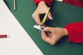 Woman cutting Christmas tree for Noel decoration. Flatlay