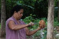 Woman cutting coconut