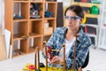 woman cutting copper pipes