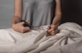 Woman cutting cotton beige fabric with sewing scissors. Dressmaker hands closeup