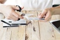 Woman is cutting credit card with scissors