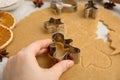 Woman cutting dough with cookie cutter at table, closeup. Christmas biscuits Royalty Free Stock Photo