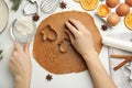 Woman cutting dough with cookie cutter at white table, top view. Christmas biscuits Royalty Free Stock Photo