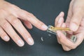 Woman cutting fingernails with nail scissors Royalty Free Stock Photo