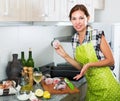 Woman cutting fish on kitchen Royalty Free Stock Photo