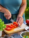 Woman cutting fresh vegetables, cooking healthy food