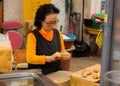 Woman cutting ginger in Dongmun Market.