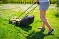 Woman cutting grass in her yard with lawn mower Royalty Free Stock Photo