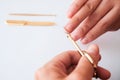 The woman is cutting her nails with small scissors by herself in close up photo on white background. View from above. Manicure at Royalty Free Stock Photo