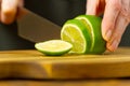 Woman cutting lime in kitchen, lemon water, Refreshing Water with lime and lemon, healthy eating concept Royalty Free Stock Photo
