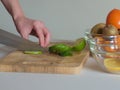 Woman cutting the lime into pieces on wooden board Royalty Free Stock Photo