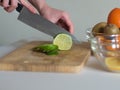 Woman cutting the lime on wooden board Royalty Free Stock Photo