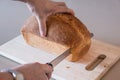 Woman cutting a loaf of white bread Royalty Free Stock Photo